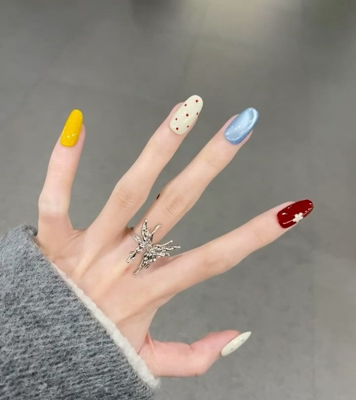 Baby blue polka dot French-style press-on nails with a blusher effect, creating a cute and sweet Instagram-worthy look